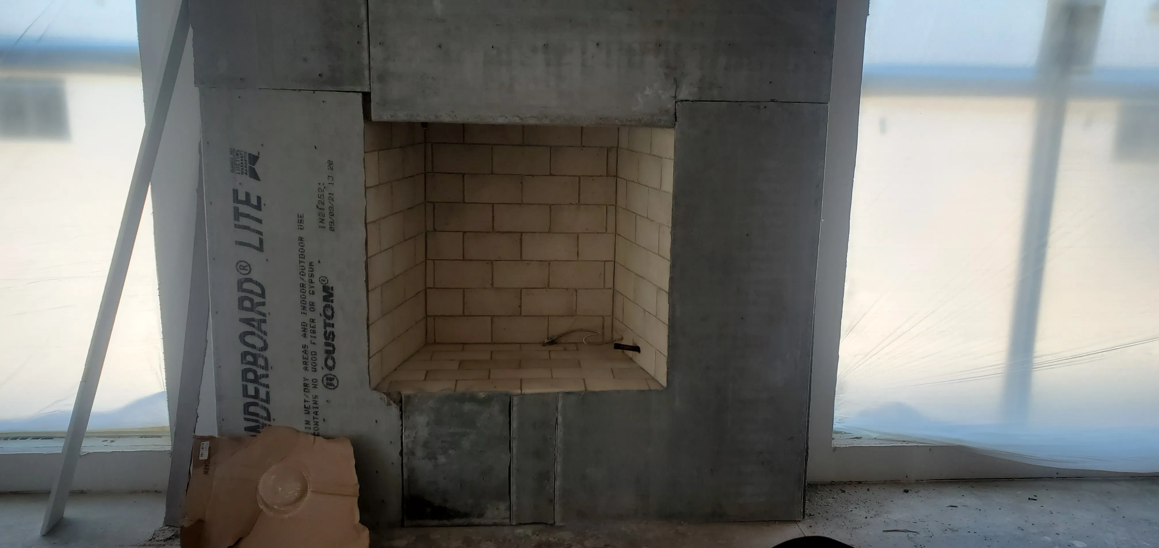 Custom firebox with cement-board surround at rough-in