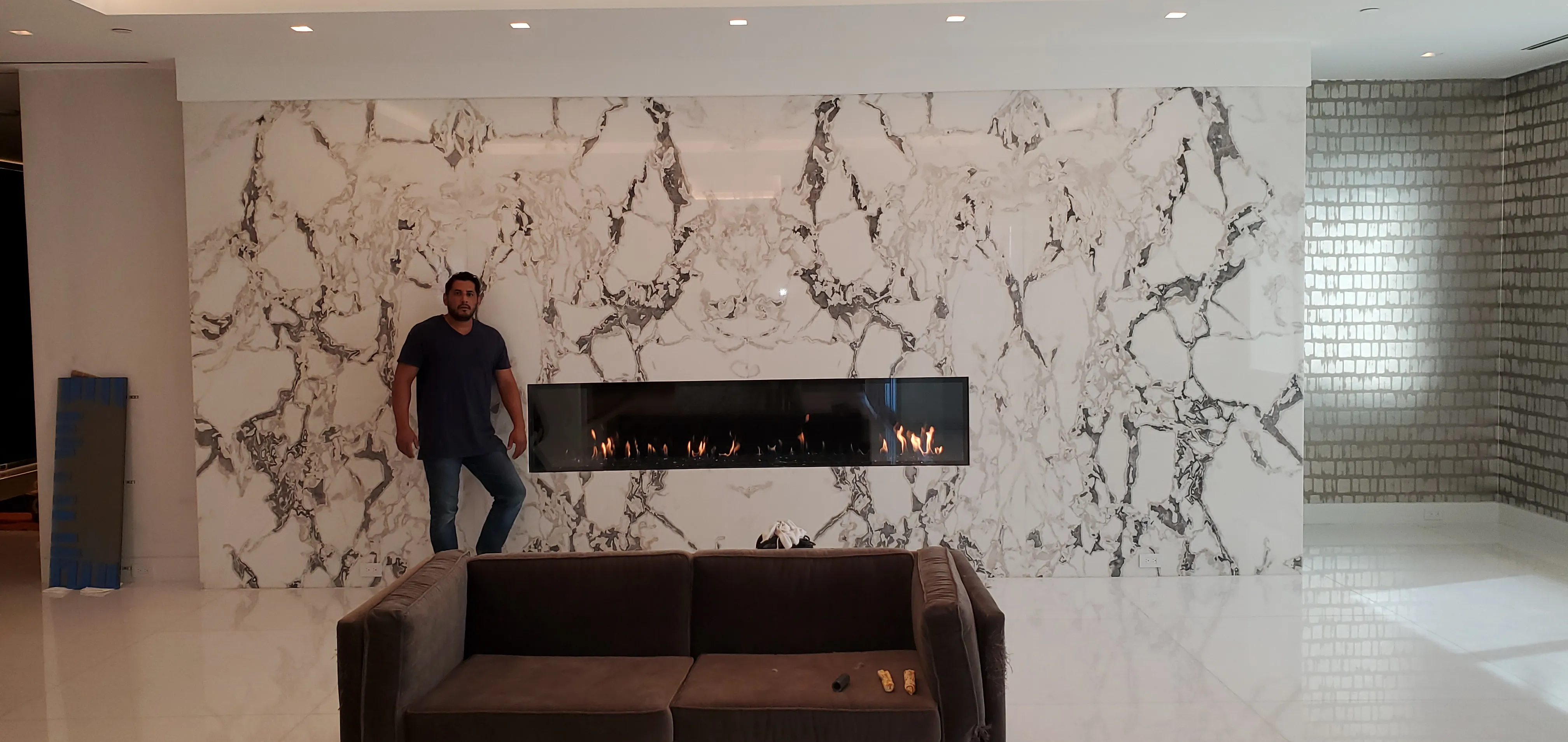 A premium marble linear gas fireplace install by Chim-Tex Construction