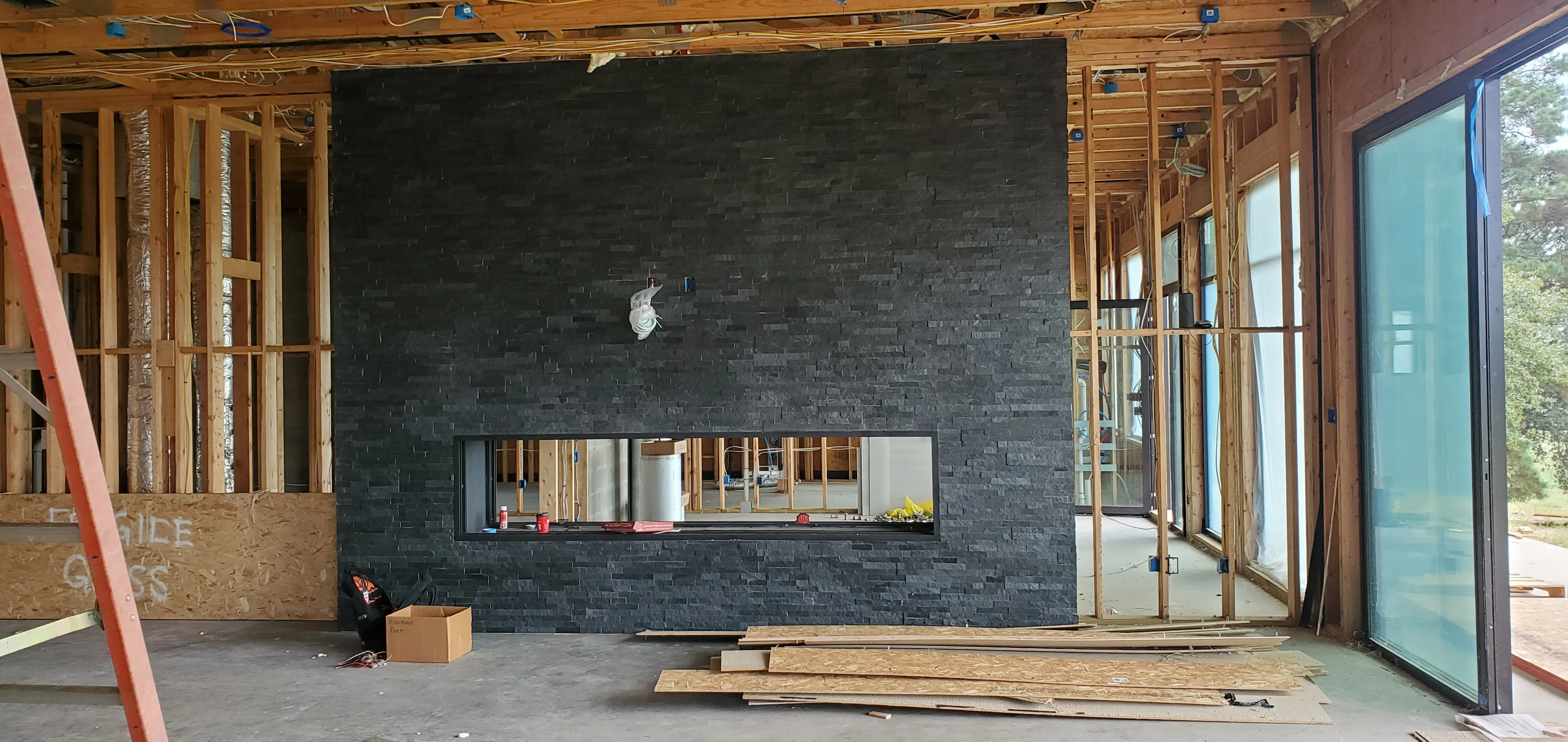 Black slate fireplace at the framing stage of a Chim-Tex custom build